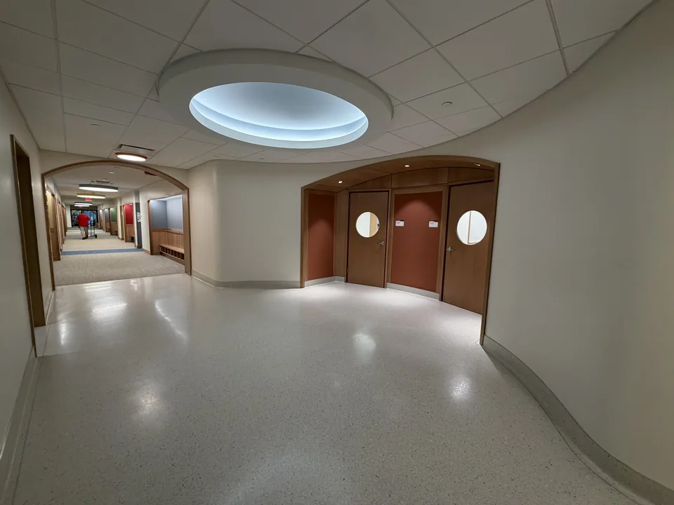 CKC wood wall panels and doors in an education hallway.
