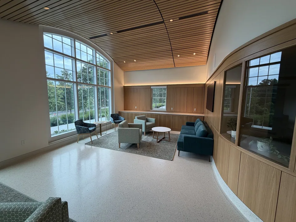 CKC custom wall paneling and wood ceiling in a commercial gathering space.