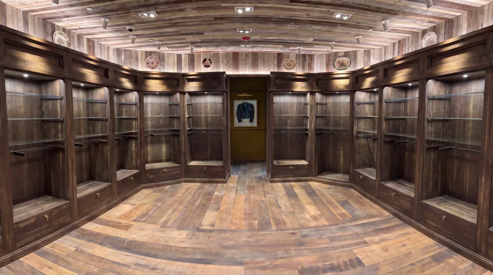 Kendra Scott retail fixture with custom dark wood display cabinetry and integrated glass shelving.